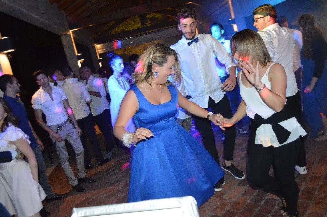 Coppia di invitate che balla durante una festa serale.