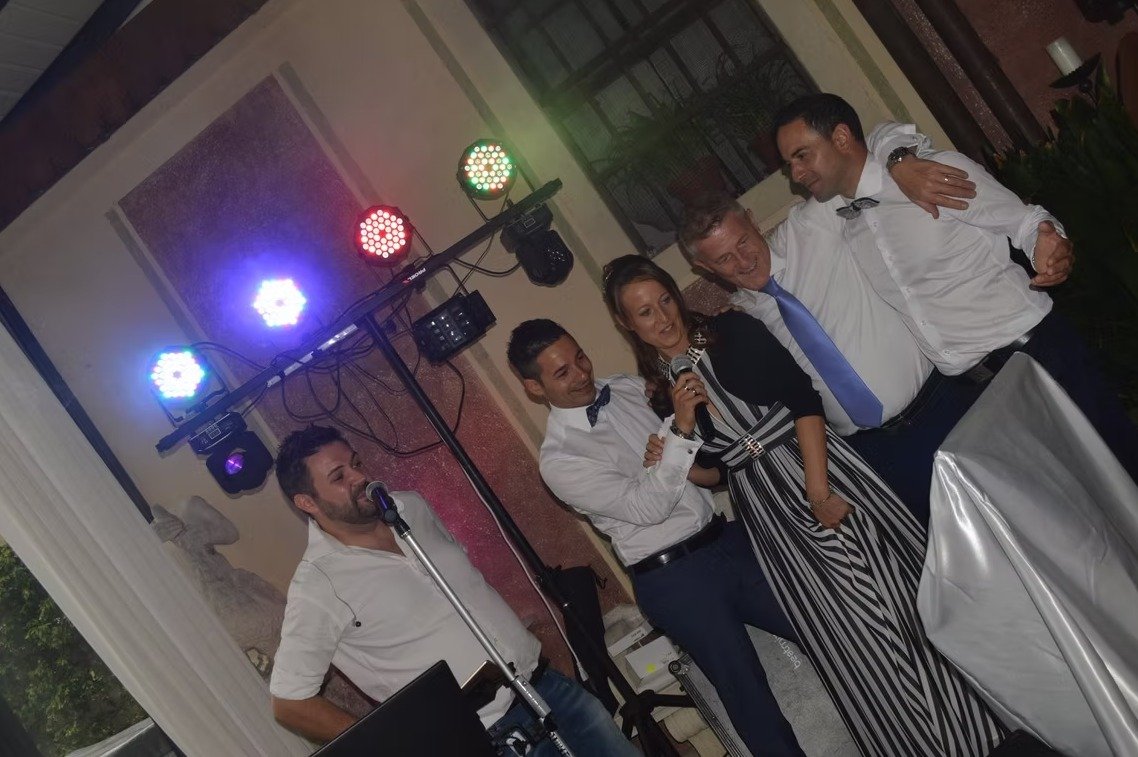 Persone che cantano al microfono durante una festa con karaoke.